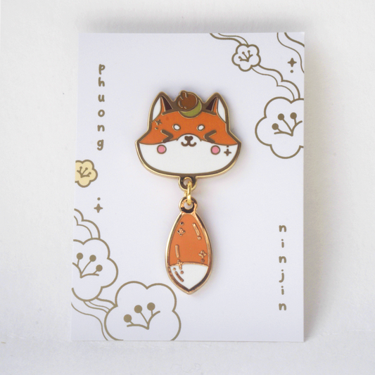 Fox enamel pin with golden outlines. Displayed here on the back card.