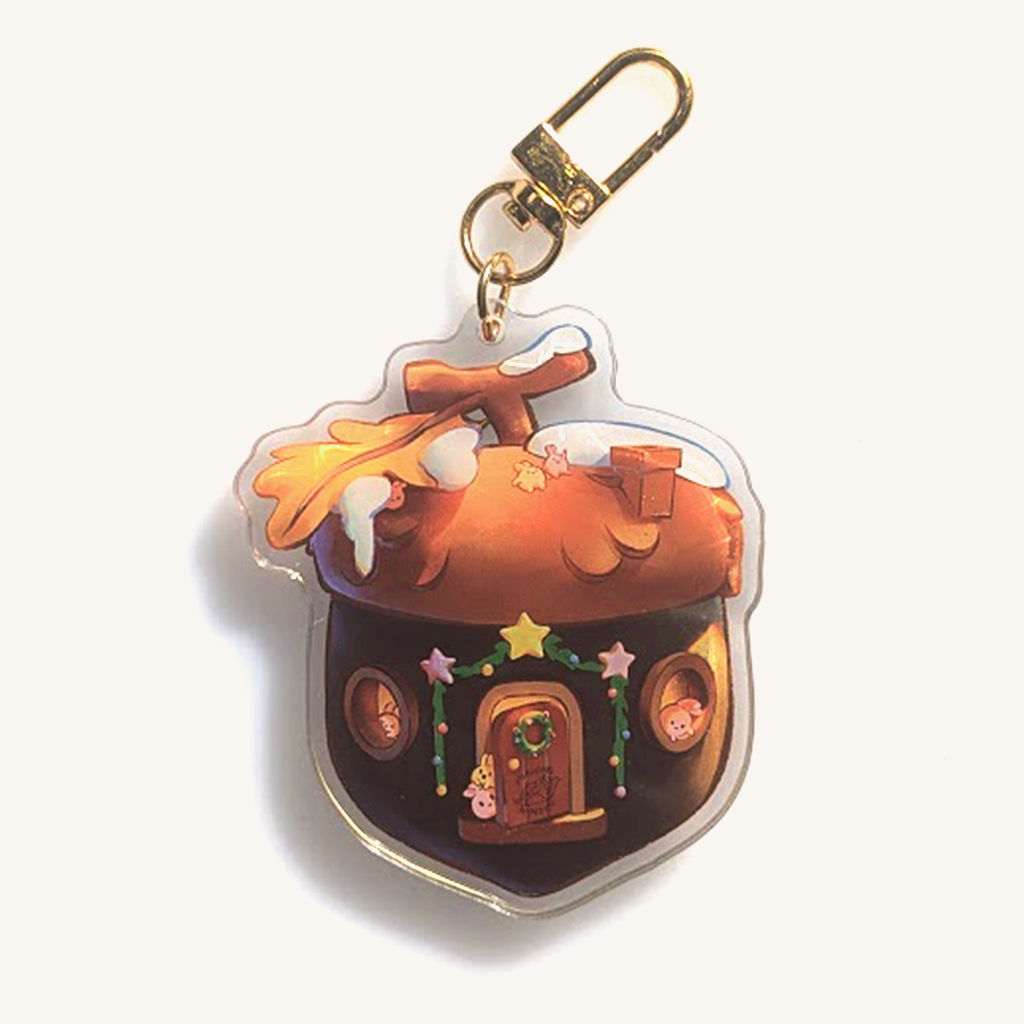 Shaker keychain with golden clamp. Portraying a wooden acorn cottage themed in Christmas decoration. Inside we also find various small bunnies hiding throughout. You can shake the shaker, with our cat Daiki, our cat Momo, and a cute bear.