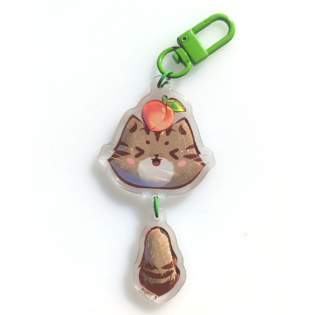 Cat Momo keychain. Double sided. With green clamp. The side shown here is her cute face.