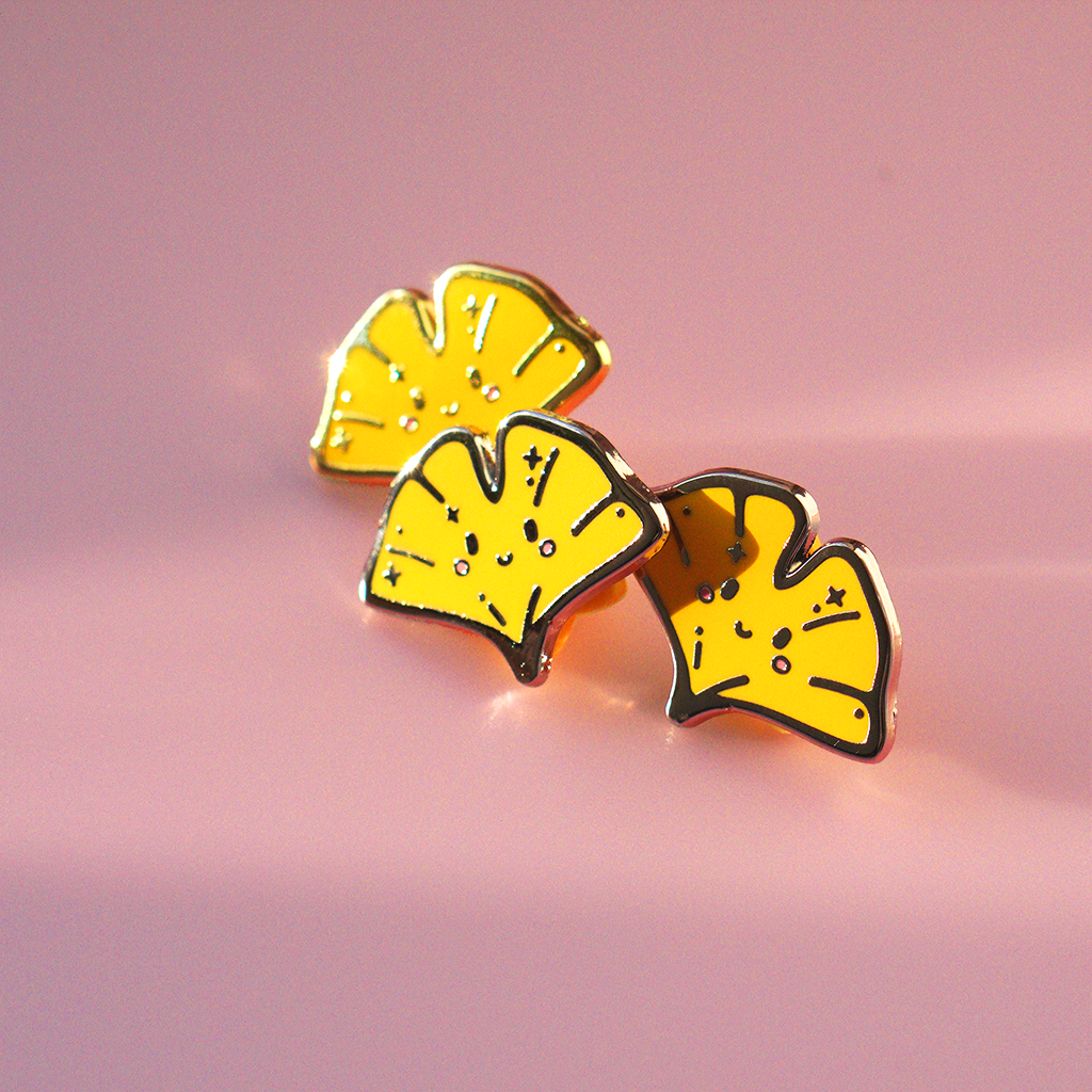 3 Ginkgo enamel pins with golden edge.
