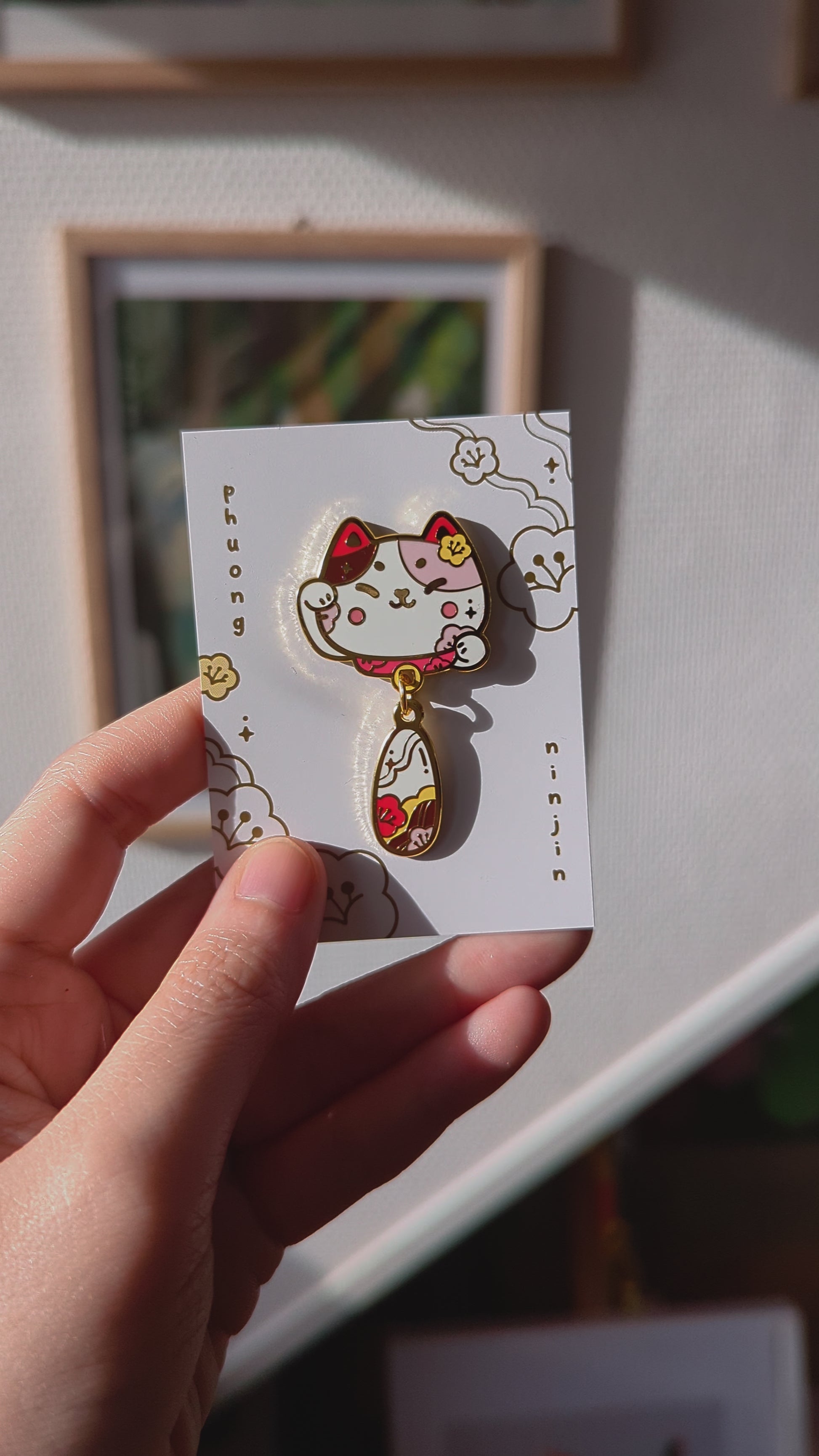 Lucky Lunar cat enamel pin displayed on our back card video