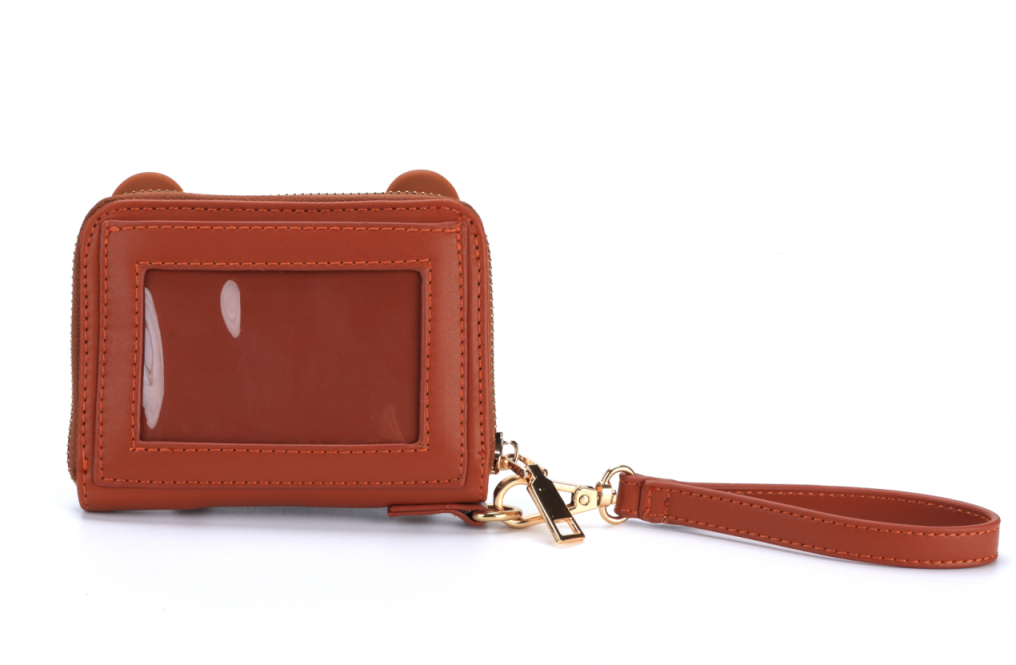 Bear shape wallet or purse. Made from vegan PU leather. Cute bear ears in silicone and face. We're shown a rear view of the exposed card holder, perfect for public transit cards.