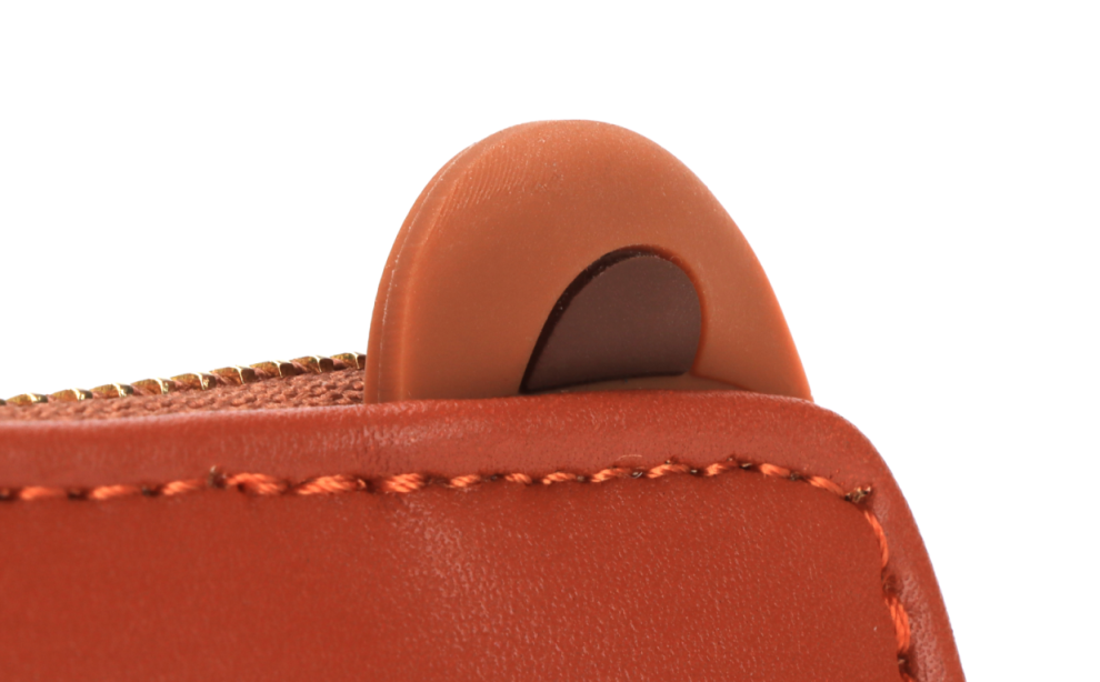 Bear shape wallet or purse. Made from vegan PU leather. Cute bear ears in silicone and face. We're shown a close up on the silicone ears