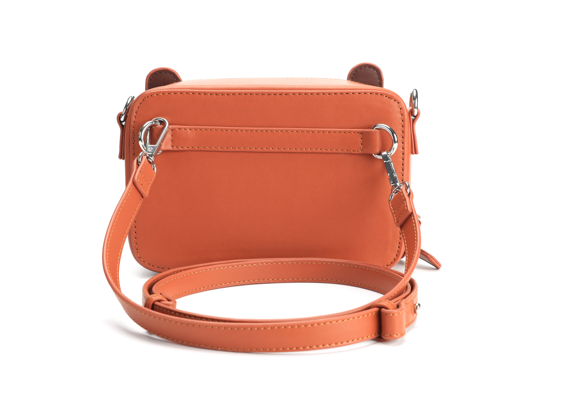 Bear box shape shoulder bag, that can be worn in multiple styles. Made from vegan PU leather. Cute bear ears in silicone and face. We're shown a rear view showing some of the alternative mounting points and shoulder strap.
