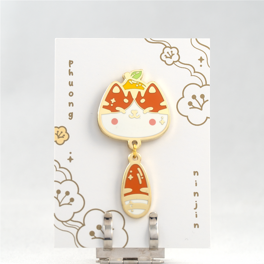 Yuzu cat with small lemon enamel pin with golden edges, displayed here on our back card
