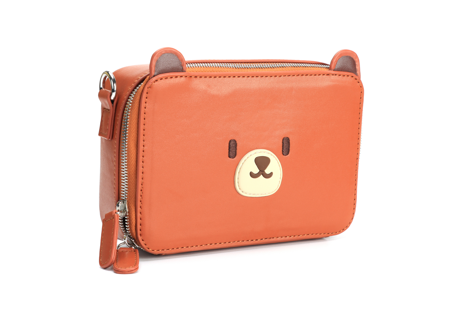 Bear box shape shoulder bag, that can be worn in multiple styles. Made from vegan PU leather. Cute bear ears in silicone and face. We're shown a slight front side angle